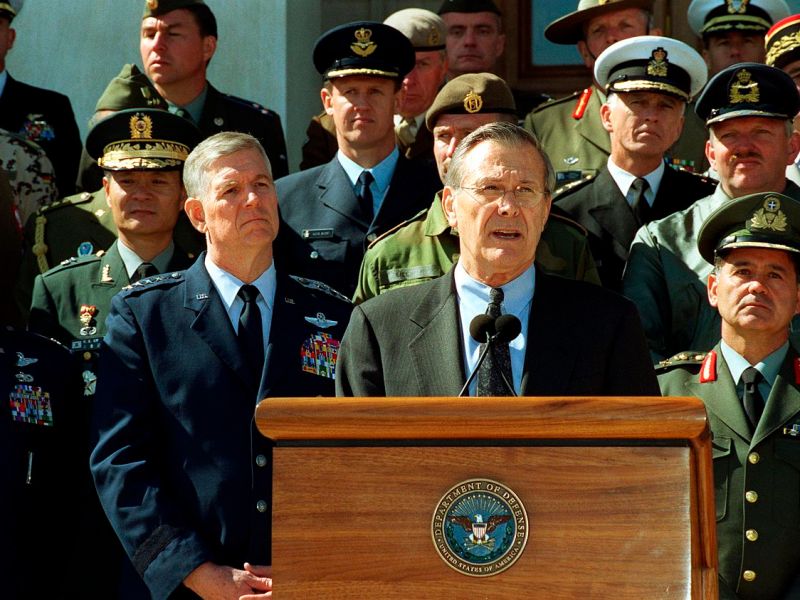 Secretary of Defense Donald Rumsfeld accompanied by Chairman of the Joint Chiefs of Staff General Richard B. Myers and joined by military representatives from 29 countries of the worldwide coalition on the war against terrorism, while speaking to the reporter outside The Pentagon on March 11, 2002.