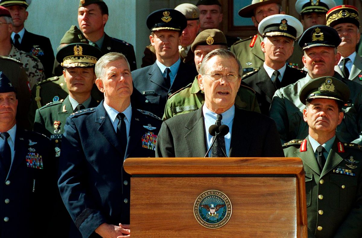 Secretary of Defense Donald Rumsfeld accompanied by Chairman of the Joint Chiefs of Staff General Richard B. Myers and joined by military representatives from 29 countries of the worldwide coalition on the war against terrorism, while speaking to the reporter outside The Pentagon on March 11, 2002.