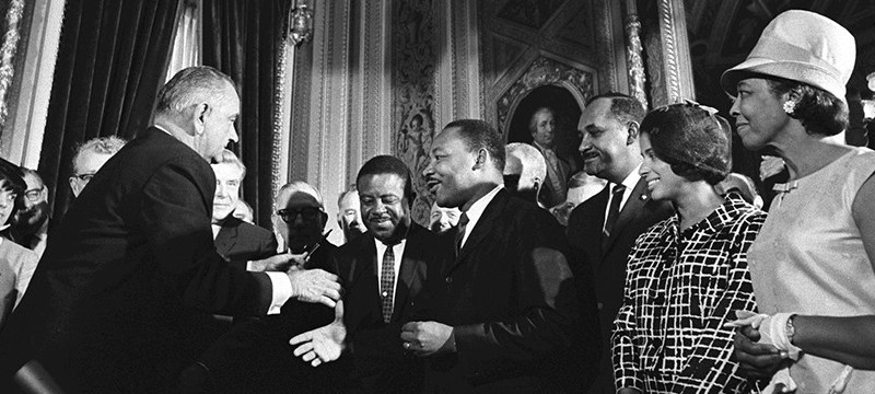 President Lyndon B. Johnson shakes hands with Dr. Martin Luther King after signing the Voting Rights Act. (LBJ Library photo by Yoichi Okamoto)