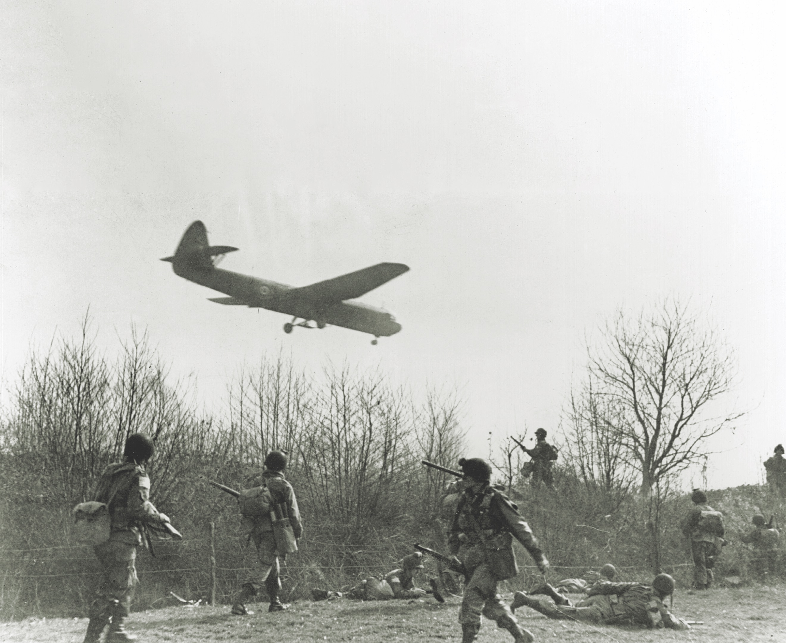 American paratroopers look on as a British Horsa glider lands with reinforcements for the push to secure the Rhine crossing. (Robert Capa/Getty Images)