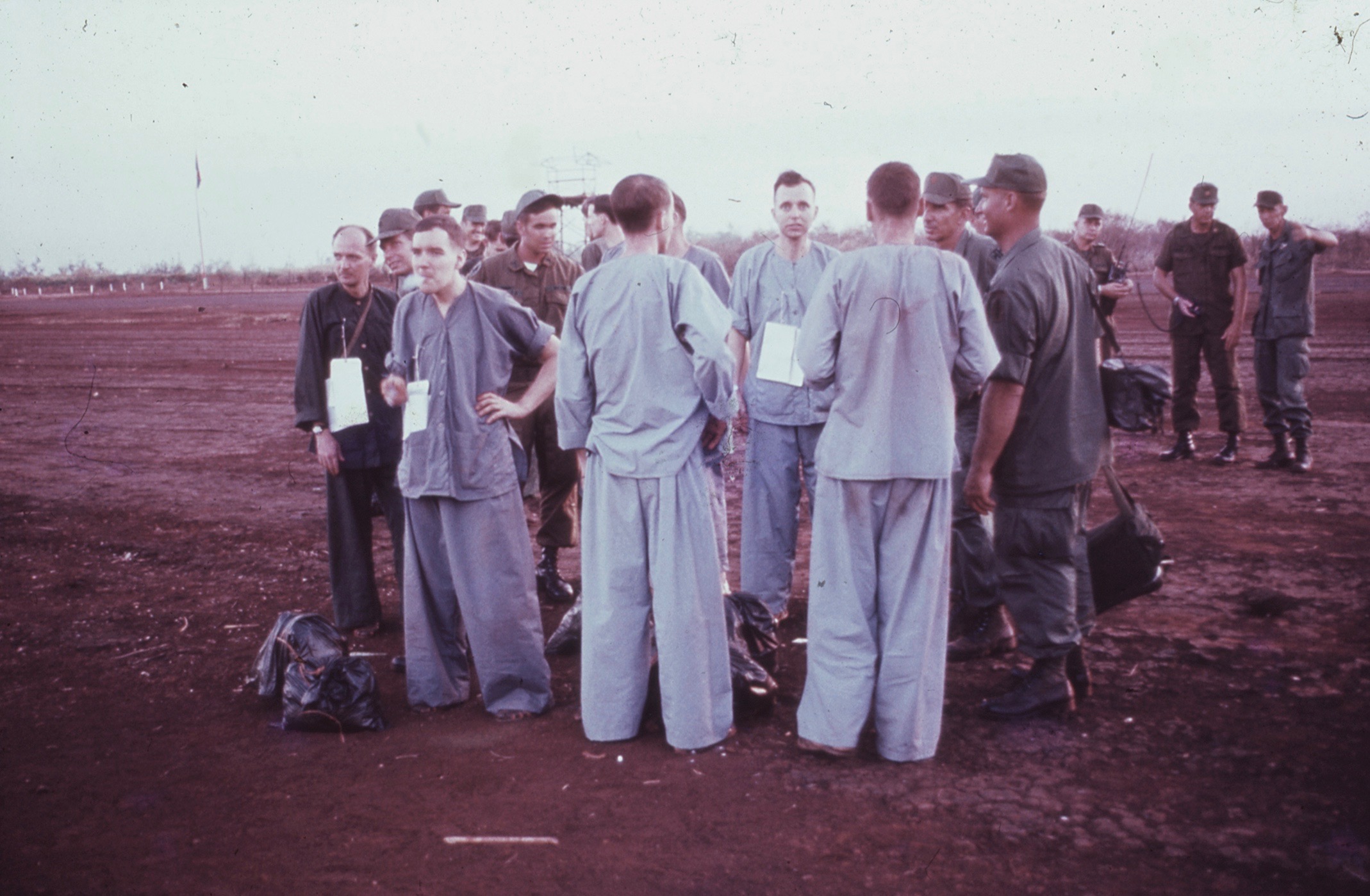 Army POWs held by the Viet Cong were driven by truck to the South Vietnamese town of Loc Ninh, near the Cambodian border, where they were released and are now being briefed by a U.S. Army officer. A helicopter took them to Saigon’s Tan Son Nhut Air Base. A C-9 Nightingale medical transport plane flew them to Clark Air Base. (U.S. Air Force)