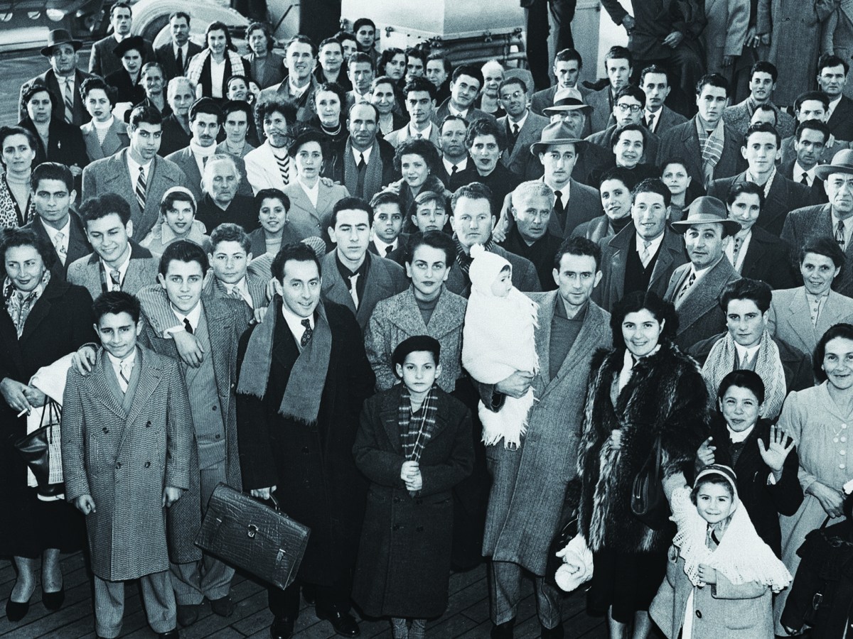 Immigrants arriving in New York from Genoa, Italy, on the deck of the liner SS Conte Giancamano at Christmas 1953. (Bettmann/Getty Images)