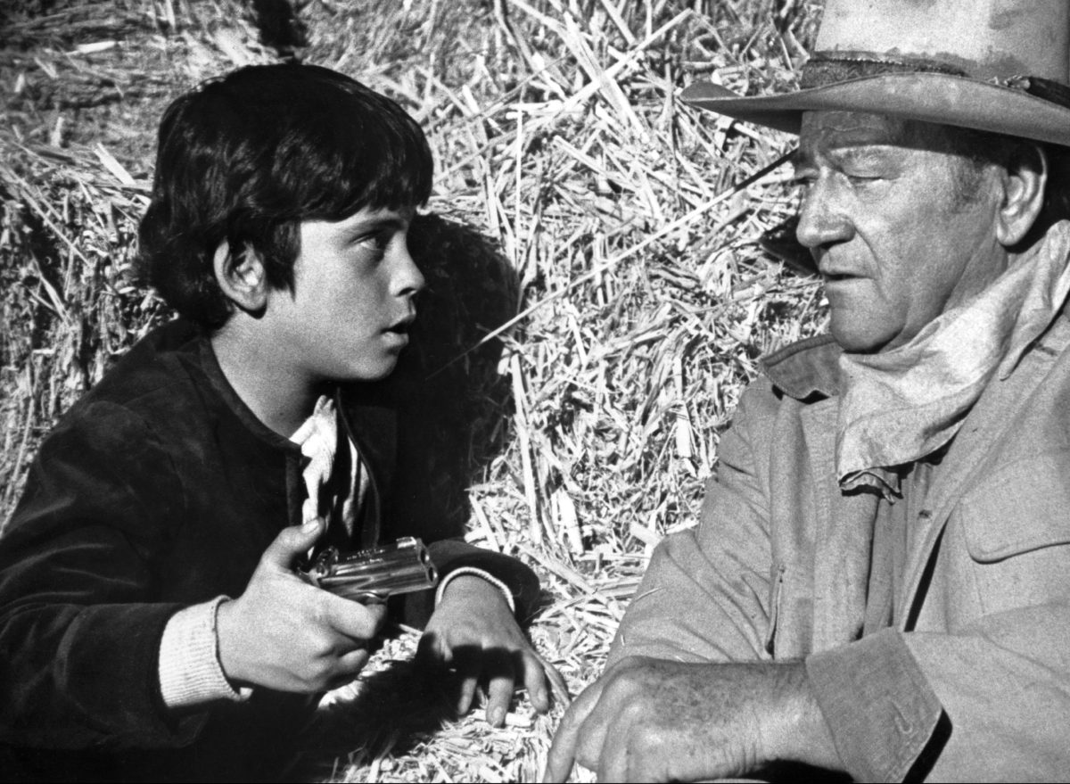 Ethan and father John Wayne in a still from the 1971 Western Big Jake