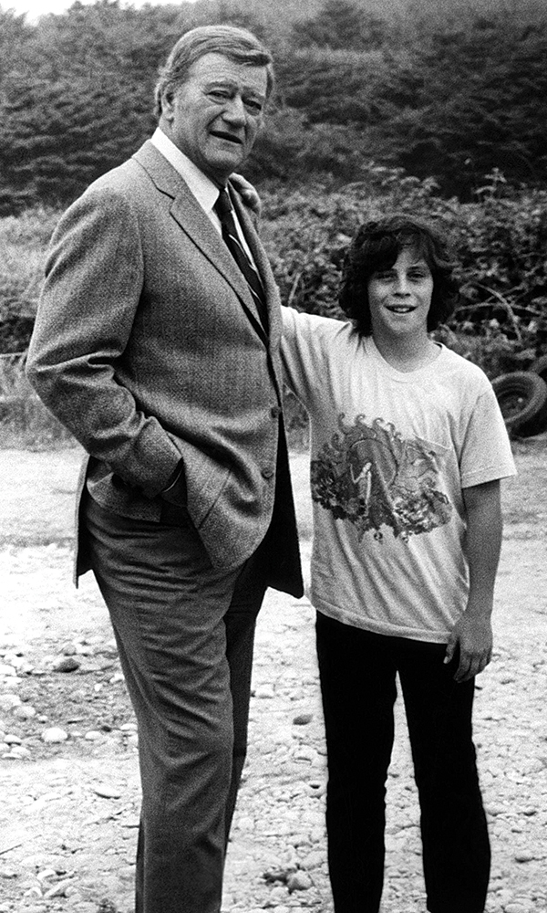A preteen Ethan Wayne poses with his famous father, John Wayne