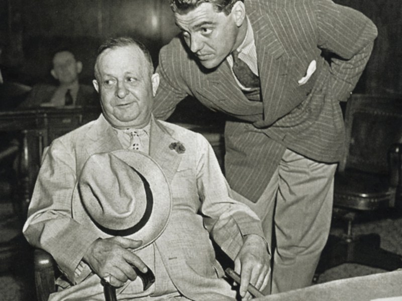 Bernstein, seated, in a New York court in 1938 with lawyer Greg Bautzer to answer charges of kiting checks.
