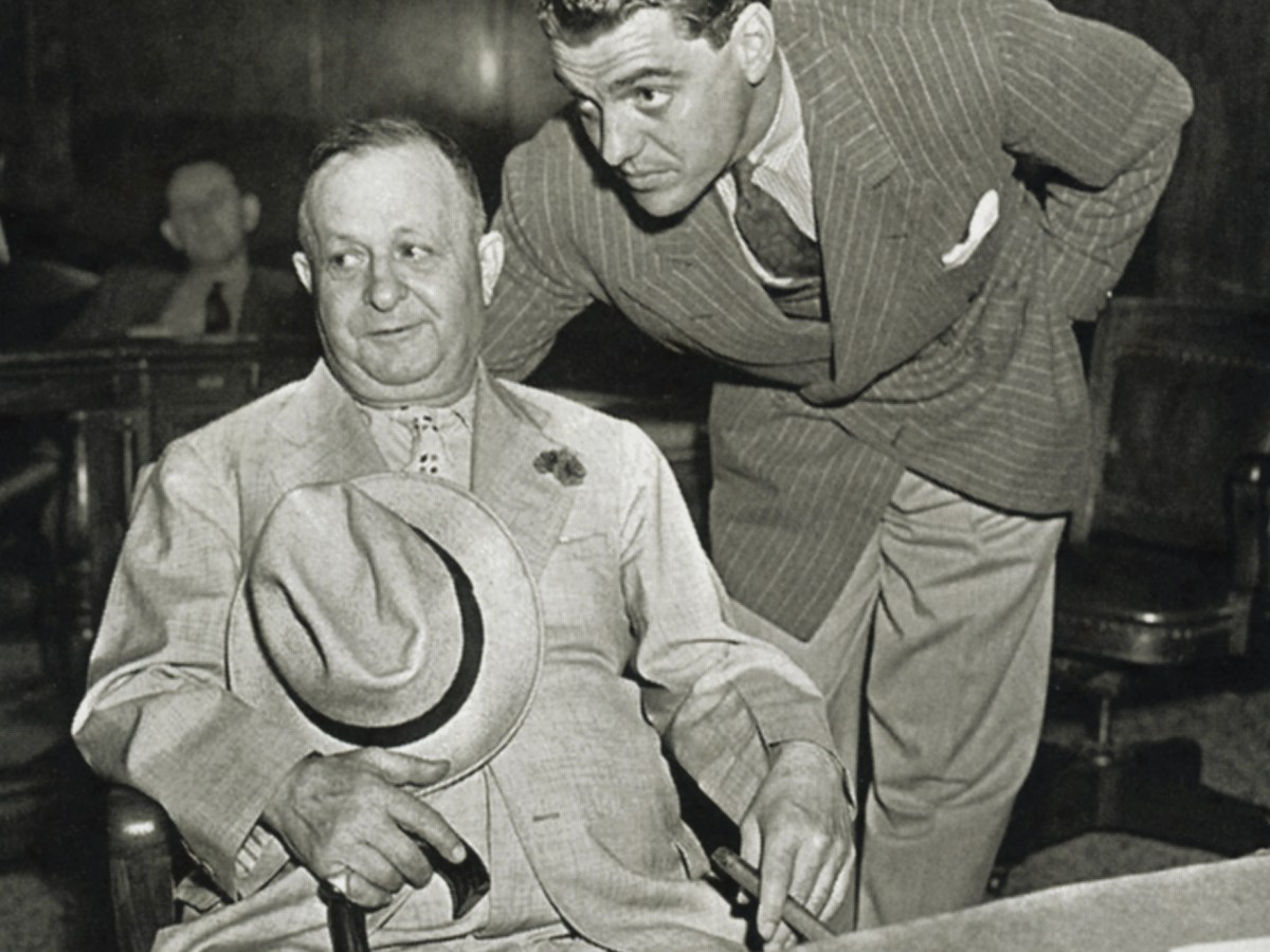 Bernstein, seated, in a New York court in 1938 with lawyer Greg Bautzer to answer charges of kiting checks.