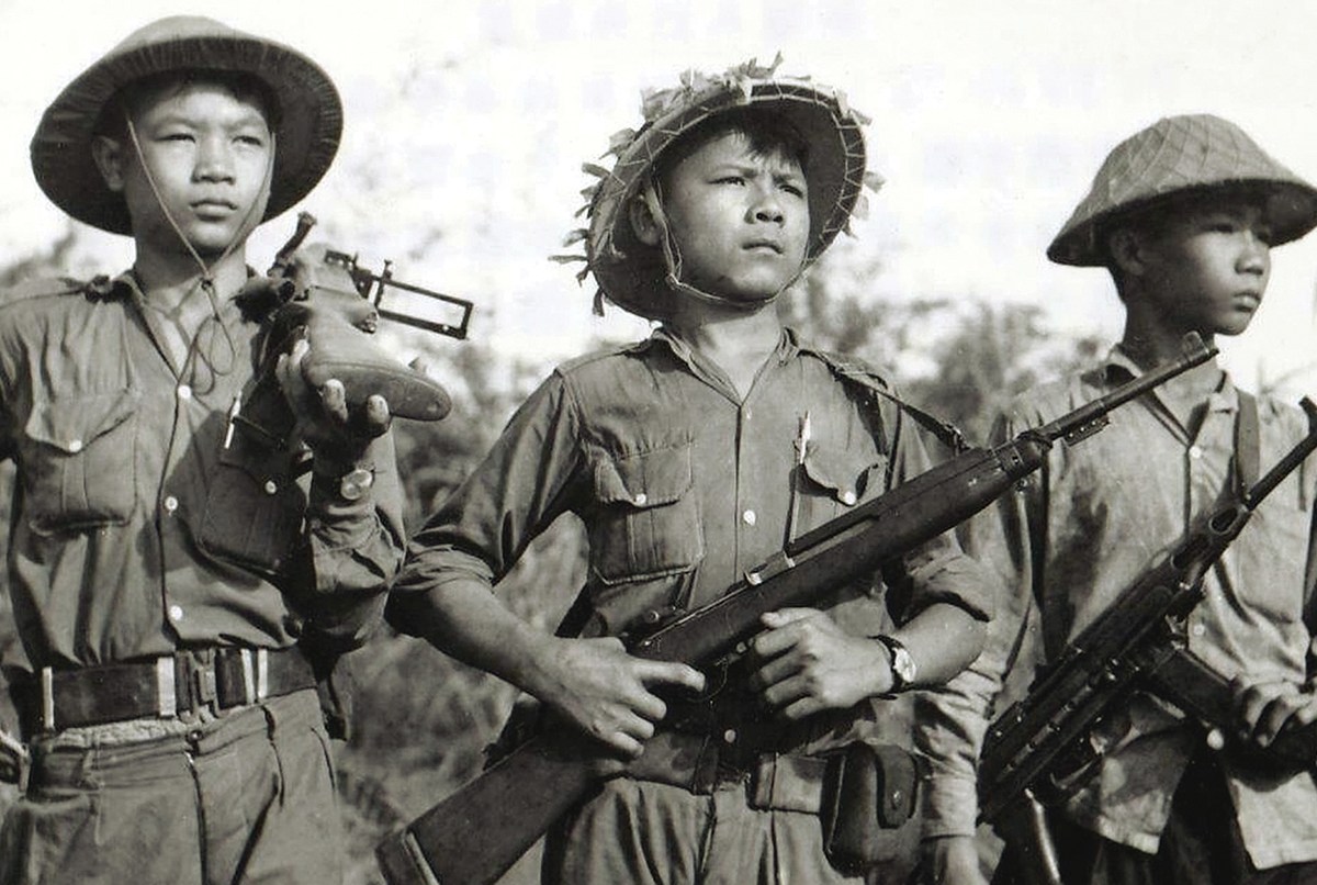 Photo of Soldiers of the National Liberation Front , the Viet Cong, in the early 1960s display weapons from a variety of sources, from left, a captured American M79 grenade launcher; an American M1 carbine, captured from the French or South Vietnamese or supplied by the Chinese; and a K-50M submachine gun supplied by North Vietnam.