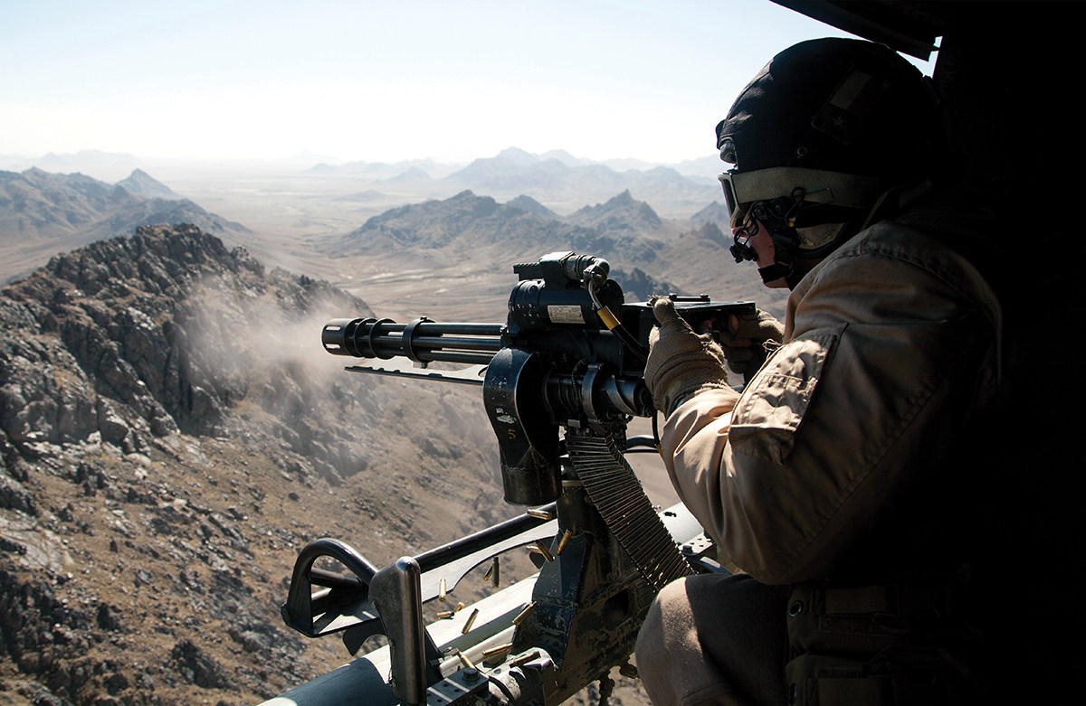 Photo of U.S. Marine Corps Sgt. Samuel Galan, a UH-1Y Venom crew chief assigned to Marine Light Helicopter Attack Squadron (HMLA) 169, opens fire while conducting an interdiction mission over Helmand province, Afghanistan, Feb. 3, 2013. Galan, from Houston, Texas, is deployed to Afghanistan in support of Operation Enduring Freedom. (U.S. Marine Corps