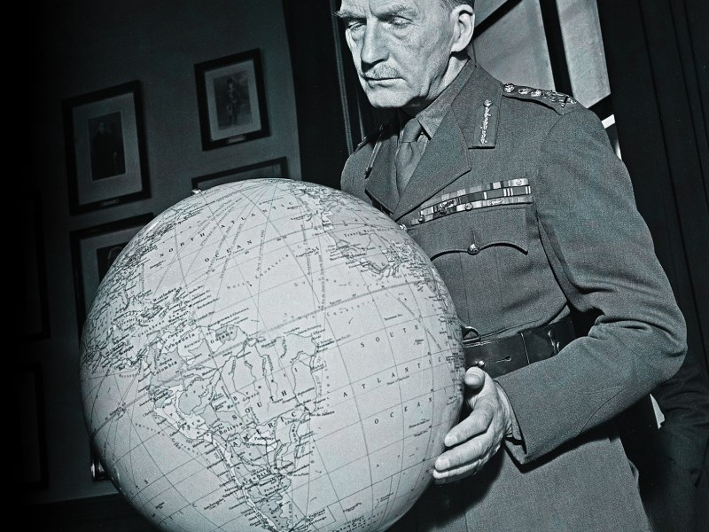 Photo of British Army officer General Sir John Greer Dill (1881-1944), Chief of the Imperial General Staff, studies a globe in his office in London during World War II in January 1941.