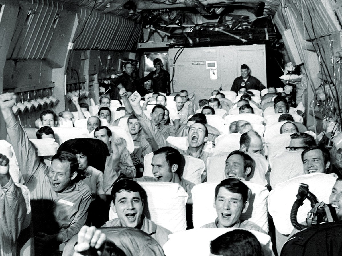 Photo of American servicemen, former prisoners of war, are cheering as their aircraft takes off from an airfield near Hanoi as part of Operation Homecoming.