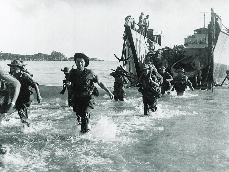 Photo of Marine commando forces of the French Expeditionary Corps wading ashore from a landing craft, in the Annam region in central Vietnam, as war operations against the Communist Viet Minh continue, on July 27, 1950.