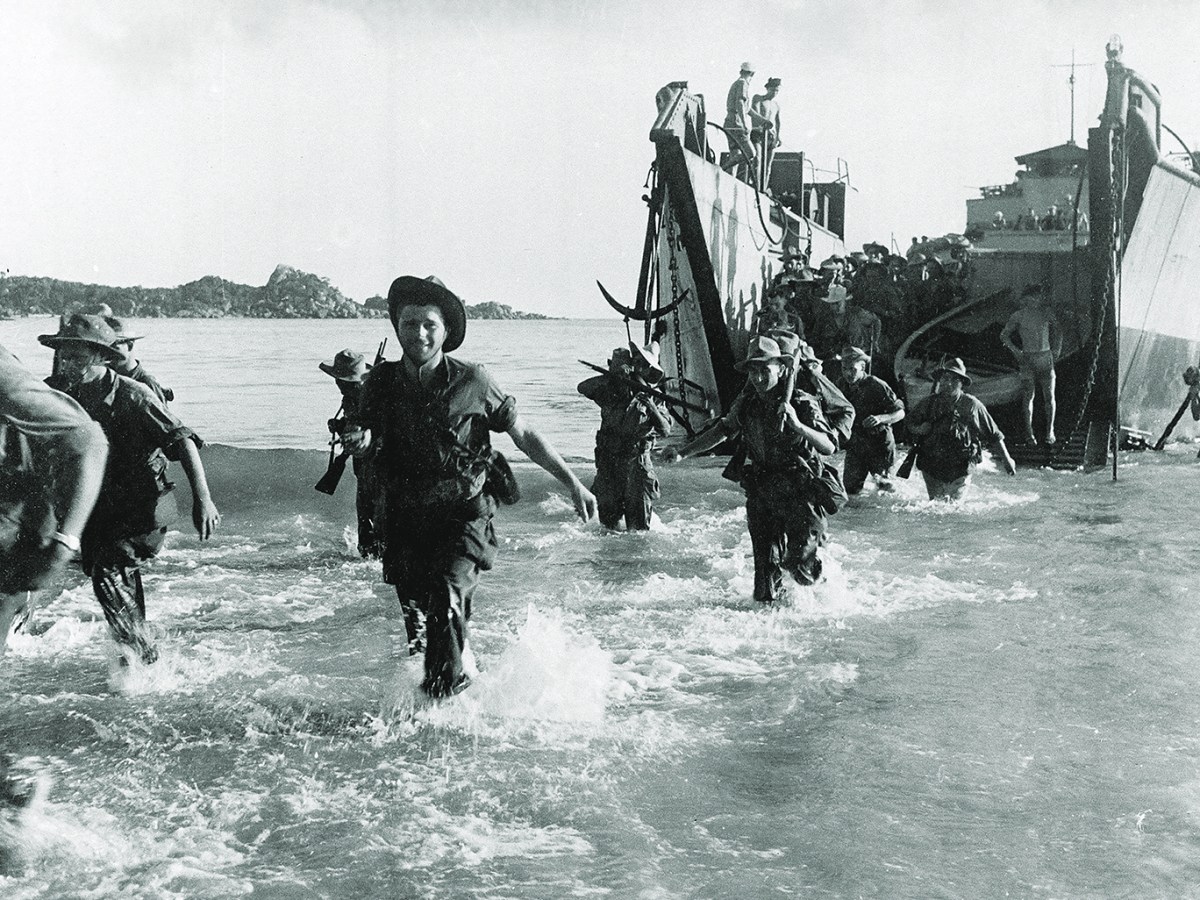 Photo of Marine commando forces of the French Expeditionary Corps wading ashore from a landing craft, in the Annam region in central Vietnam, as war operations against the Communist Viet Minh continue, on July 27, 1950.