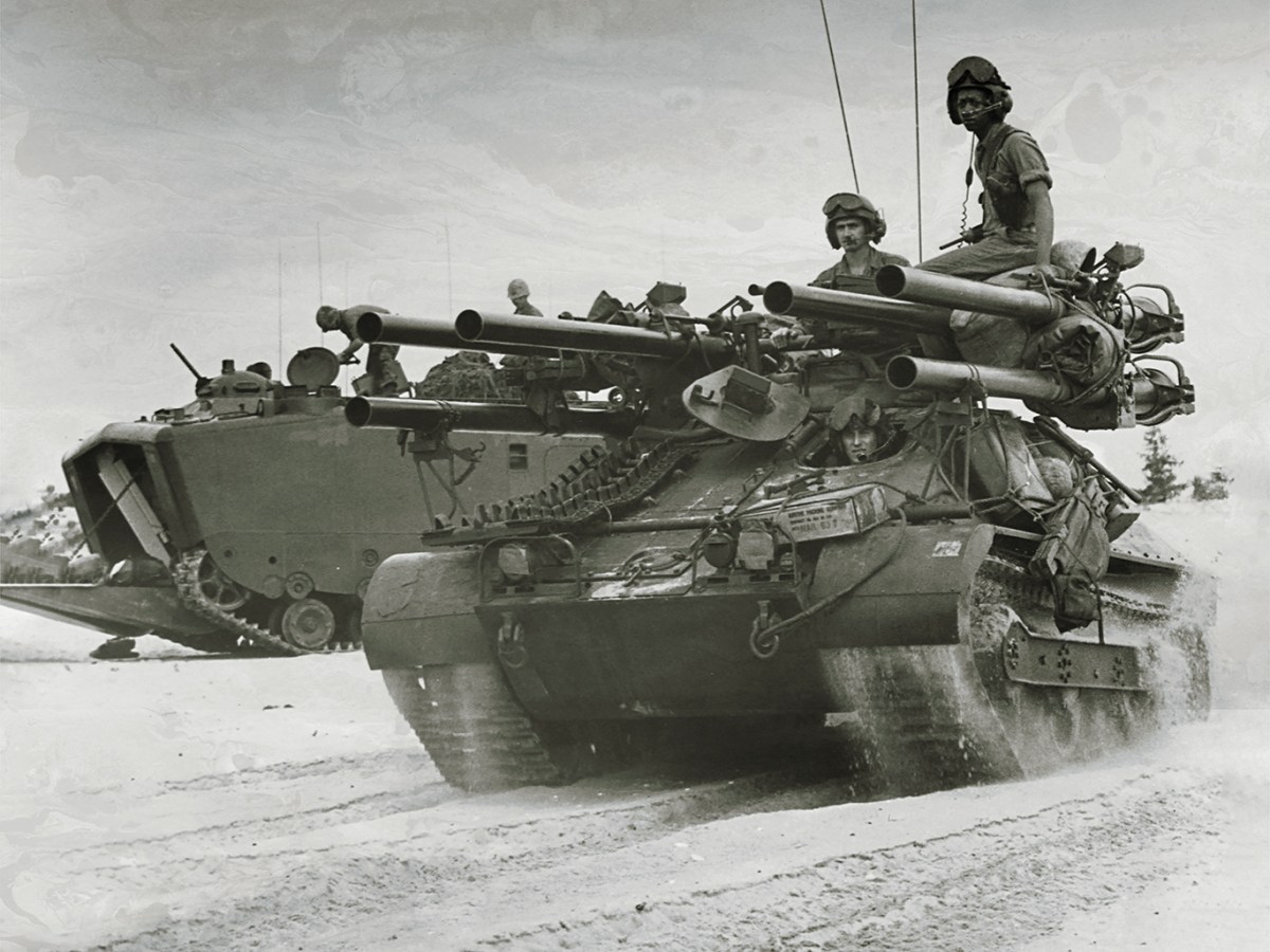 Photo of American forces on Chu Lai beach searching for a defensive position shortly after descending from the landing crafts aboard the USS Thomaston. Vietnam, June 1965.