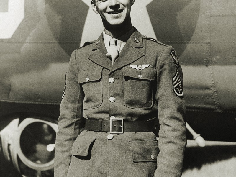 Photo of Staff Sergeant Maynard H. smith, of Caro, Michigan, is the first enlisted man in the European Theater of operations to be recommended for the Congressional Medal of honor. his amazing cool-headedness and bravery after a Flying Fortress raid on St. Nazaire earns him that honor. with three members of the crew baled out, Sergeant Smith managed to administer aid to the wounded tail gunner, blast at Nazis from the two waist guns, and fight fire and removing popping ammunition all at once. Sergeant smith was tail gunner and completely cut off from the pilot and co-pilot. his fire fighting and first aide action saved his ship and the lives of all aboard.