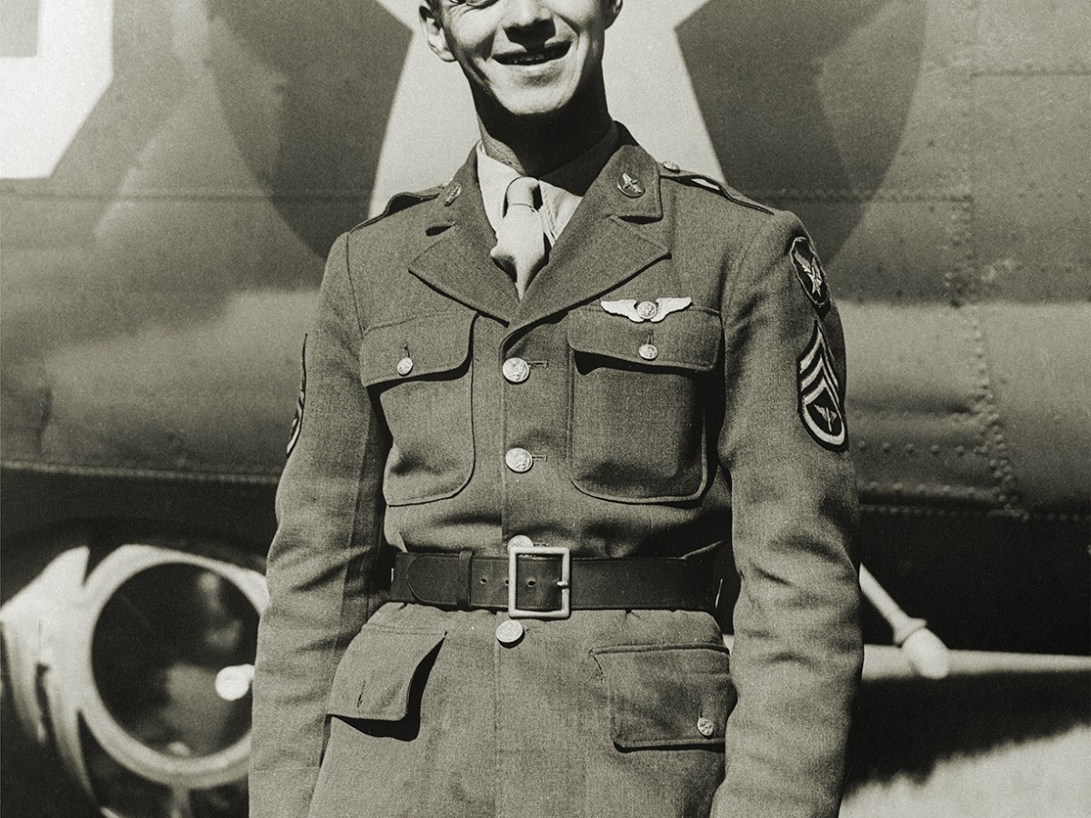 Photo of Staff Sergeant Maynard H. smith, of Caro, Michigan, is the first enlisted man in the European Theater of operations to be recommended for the Congressional Medal of honor. his amazing cool-headedness and bravery after a Flying Fortress raid on St. Nazaire earns him that honor. with three members of the crew baled out, Sergeant Smith managed to administer aid to the wounded tail gunner, blast at Nazis from the two waist guns, and fight fire and removing popping ammunition all at once. Sergeant smith was tail gunner and completely cut off from the pilot and co-pilot. his fire fighting and first aide action saved his ship and the lives of all aboard.