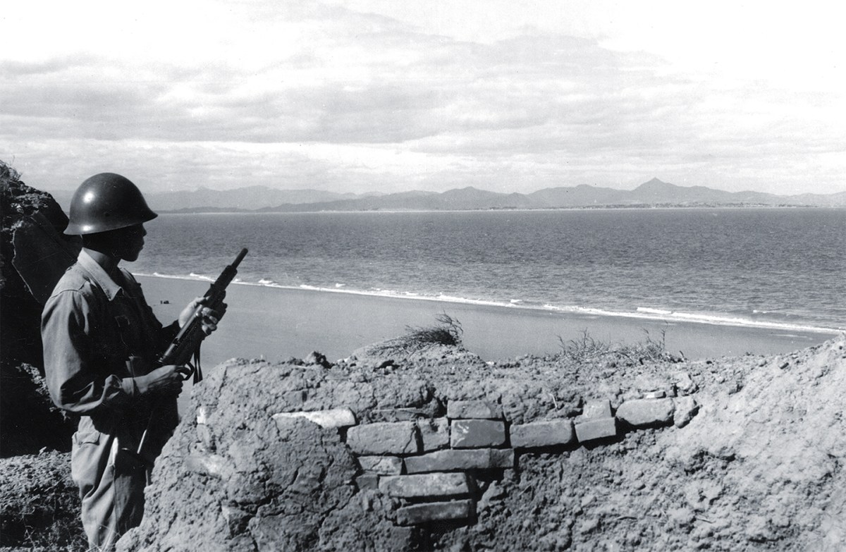 photo of A Nationalist sentinel on the Island of Quemoy watching the Communists' positions on the shore of Mao Tse-tun's China. Kinmen, November 1954