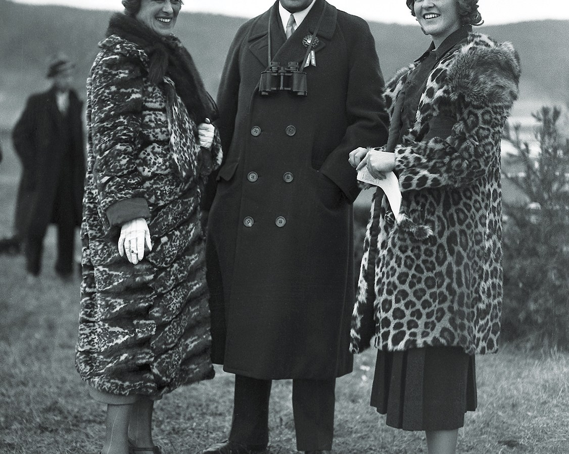 Photo of American financier and president of the New York Stock Exchange Richard Whitney poses with his wife Gertrude (nee Sheldon Sands) and his daughter Nancy at an unidentified event, 1934.