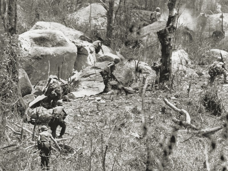 Photo of U.S. Marines are being fired upon as they charge entrenched troops of North Vietnam’s 2nd division on hill 441, near Hiep Duc Valley, South Vietnam on August 26, 1969.