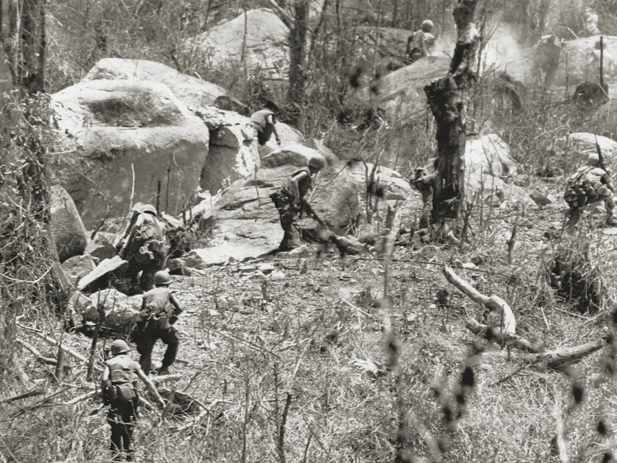 Photo of U.S. Marines are being fired upon as they charge entrenched troops of North Vietnam’s 2nd division on hill 441, near Hiep Duc Valley, South Vietnam on August 26, 1969.