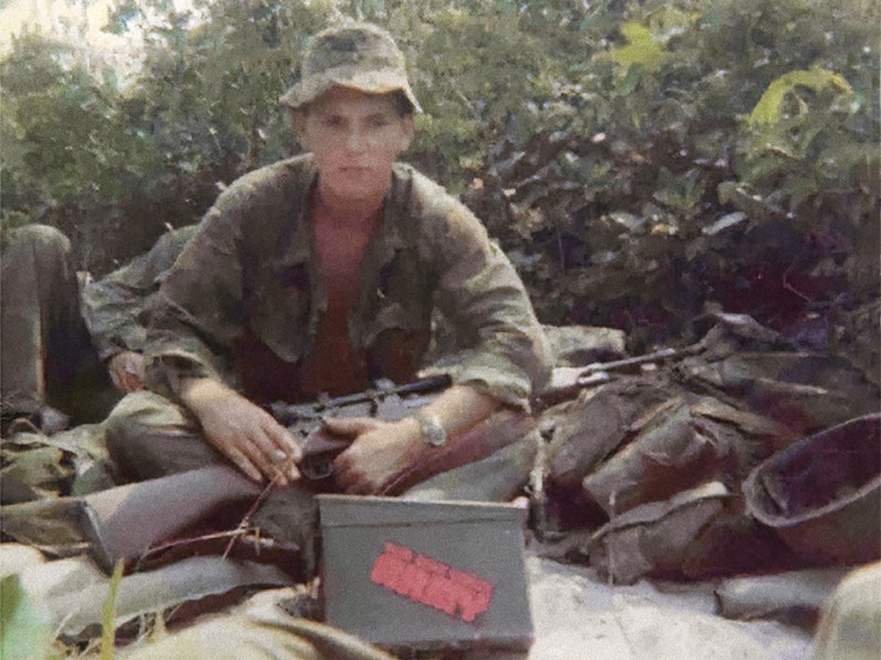 Photo of Adelbert F. Waldron III with rifle.