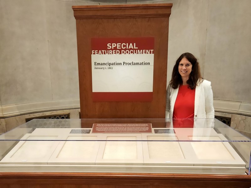 Dr. Colleen Shogan behind display case