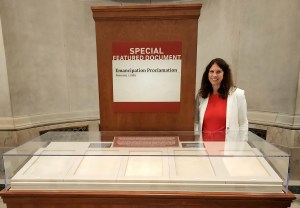 Dr. Colleen Shogan behind display case