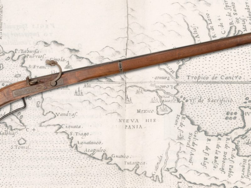 Spanish harquebus laid over map of North America