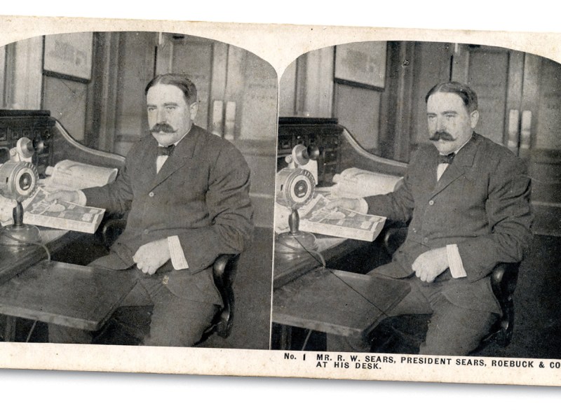 Stereographic view of R.W. Sears at desk.