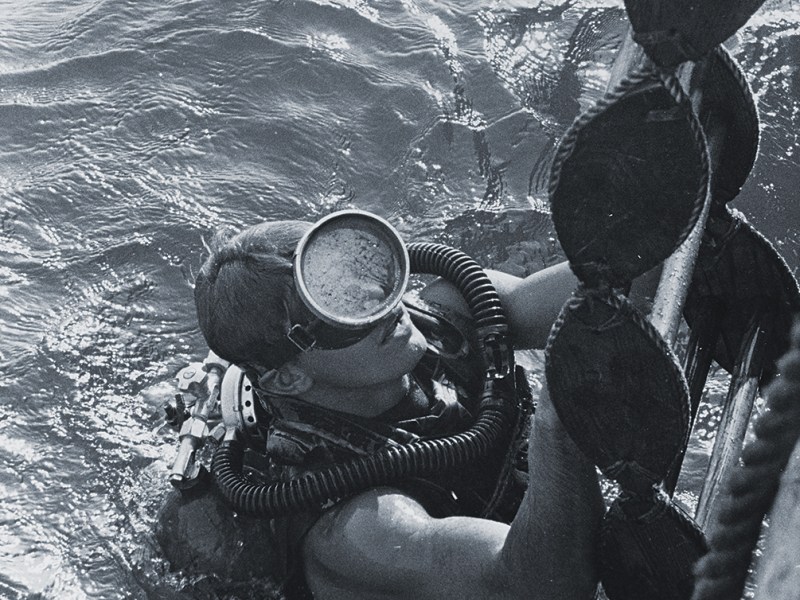 Photo of a U.S. Navy SEAL surfacing from a dive. SEALs and UDT divers were tasked with getting ashore and guiding the POWs to safety.