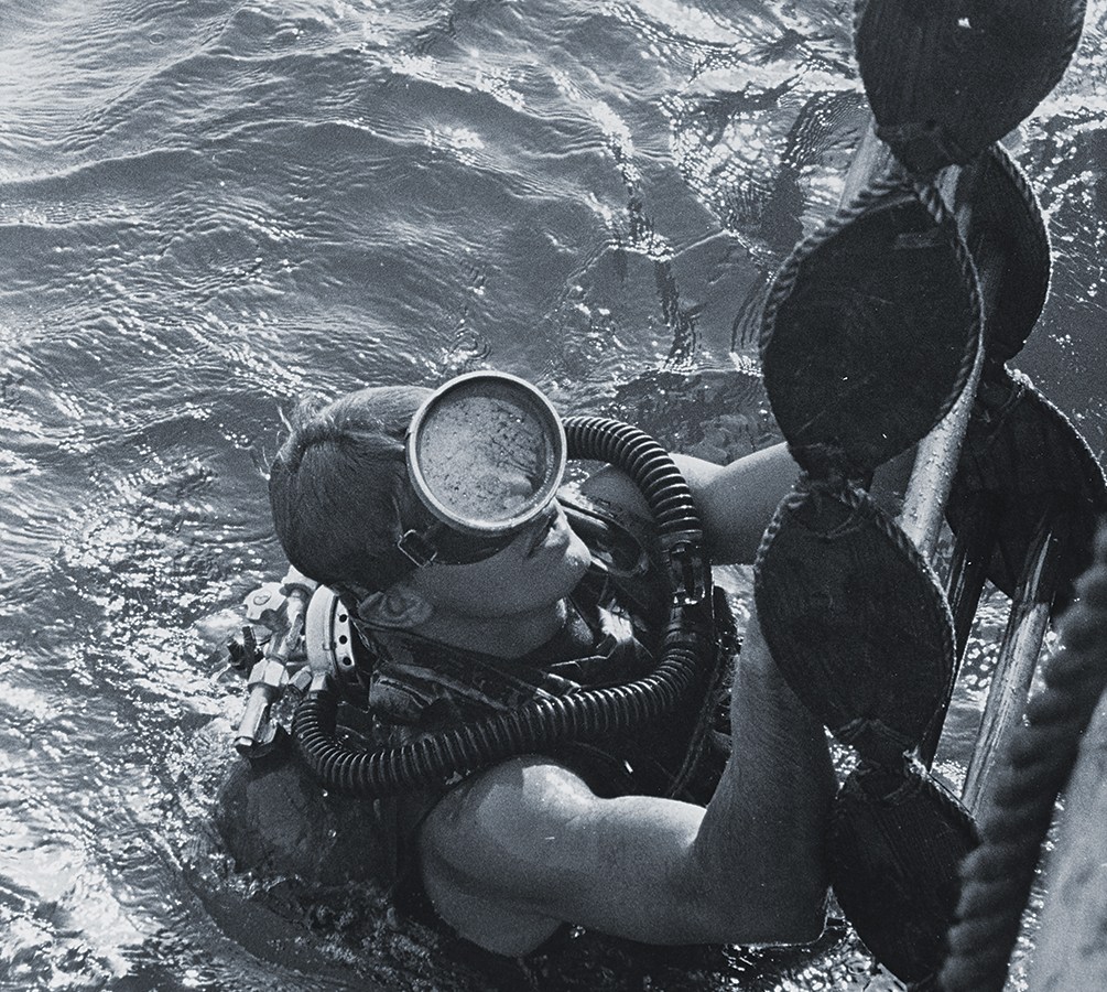 Photo of a U.S. Navy SEAL surfacing from a dive. SEALs and UDT divers were tasked with getting ashore and guiding the POWs to safety.
