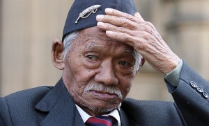 Photo of Honorary Sergeant Lachiman Gurung outside the Houses of Parliament in London.